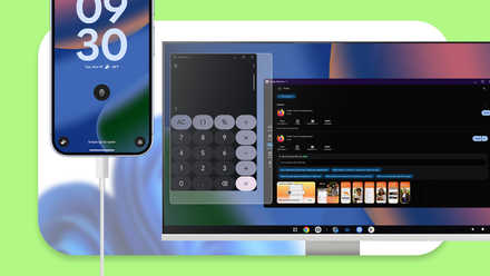 Um smartphone conectado a um monitor exibindo uma interface de desktop Android com aplicativos em janelas flutuantes.