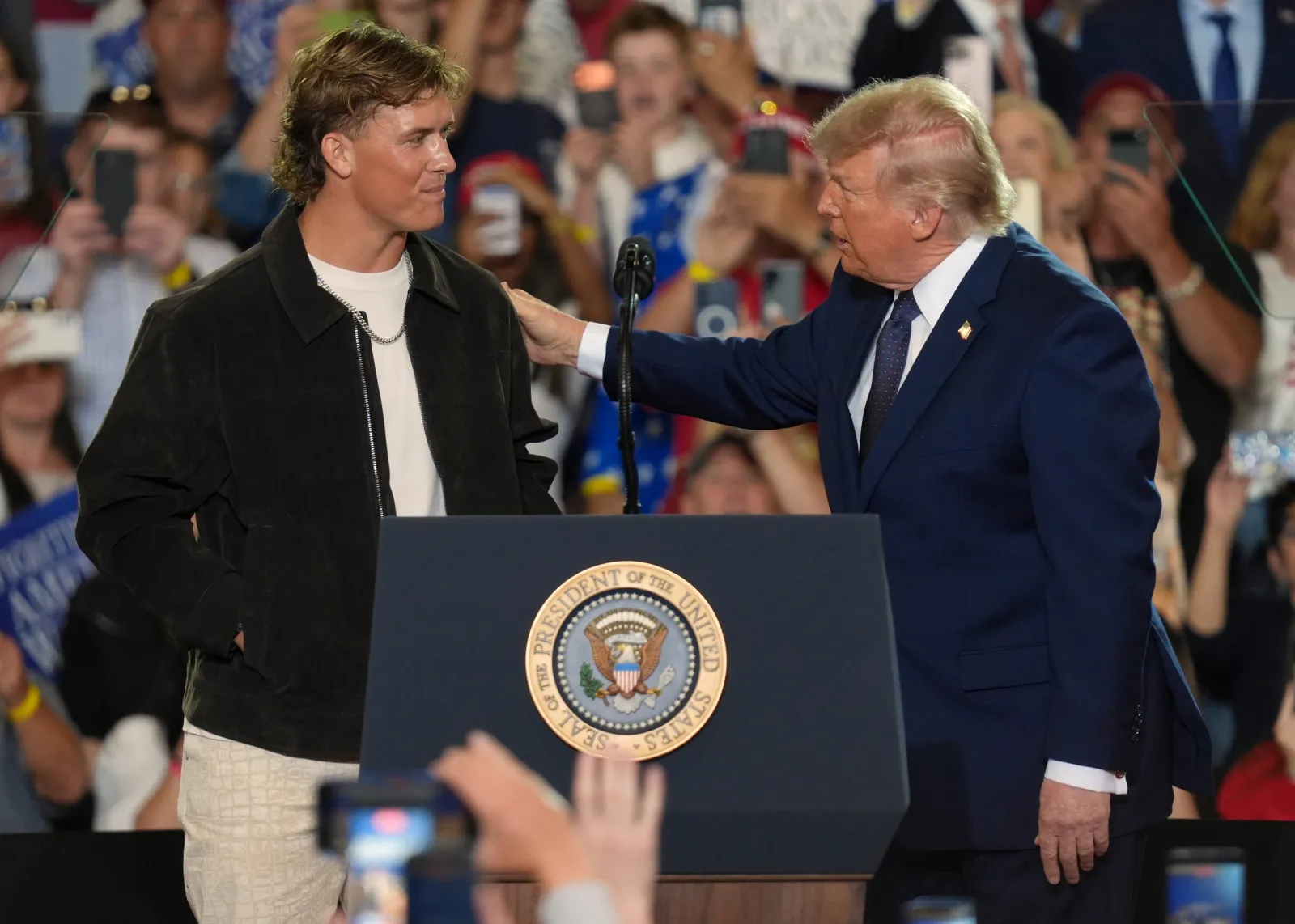 NFL quarterback Jaxson Dart, with the New York Giants introduces President Donald Trump during a